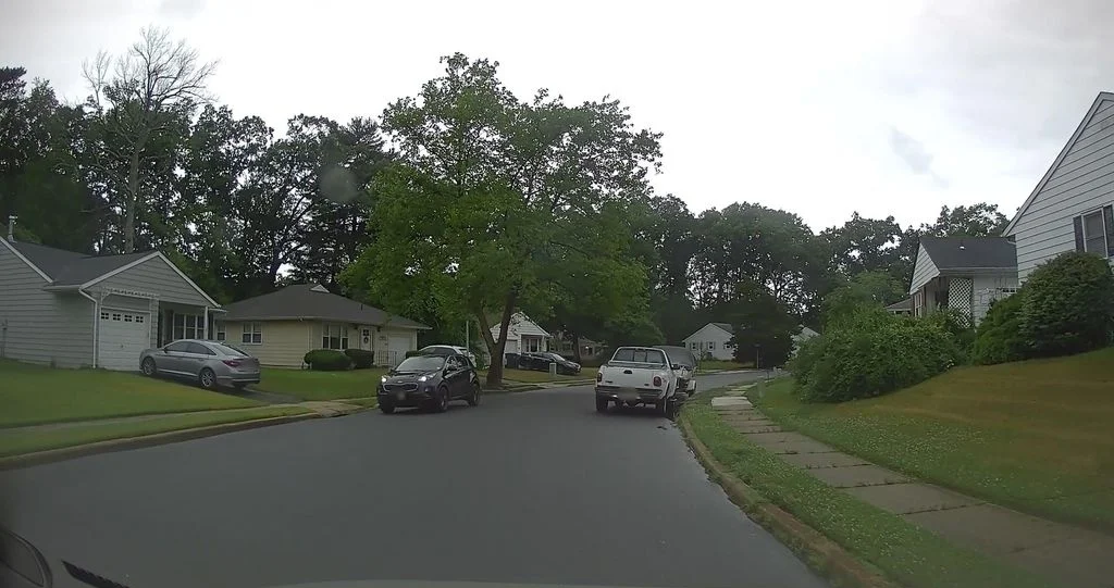 Single-story homes with driveways along a quiet street