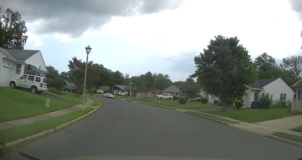 Residential street with lamp posts and ranch homes