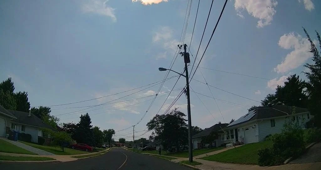 Ranch homes and a street light along a quiet street