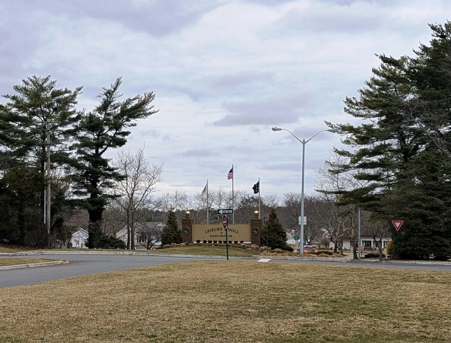 Leisure Knoll entrance sign with flagpoles