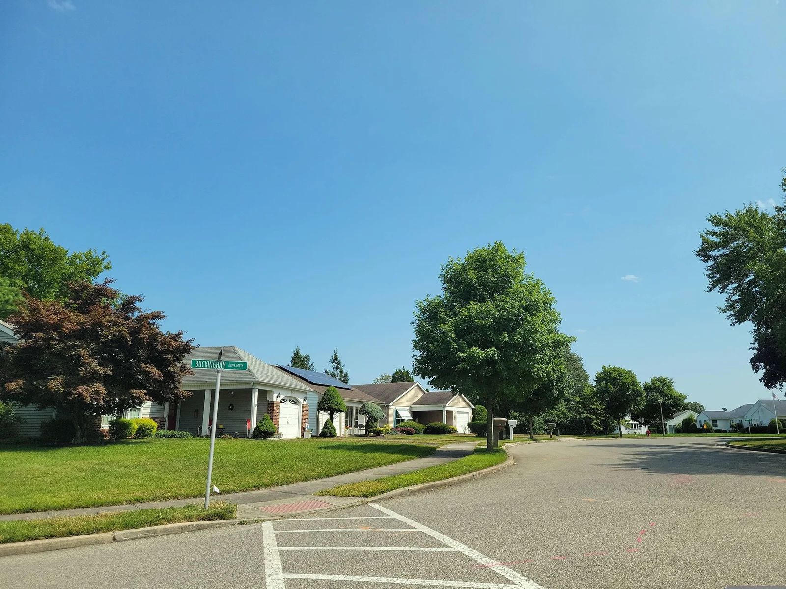 Corner with a crosswalk, lawns and single-story homes