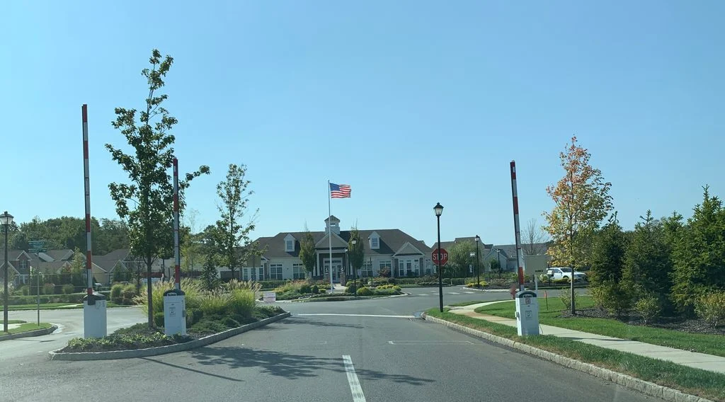 Clubhouse with an American flag on a pole at the end of the entrance drive