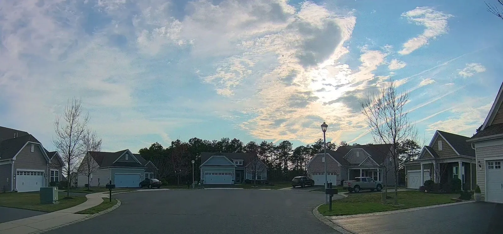 Street curving between single-family homes