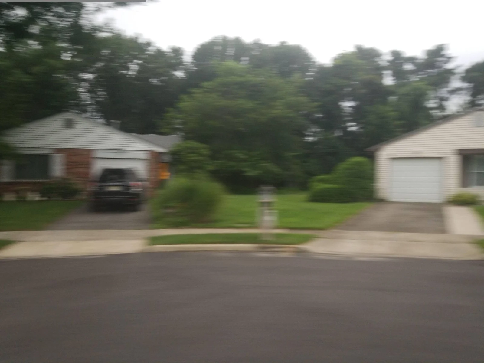 Two homes with garages at a street corner