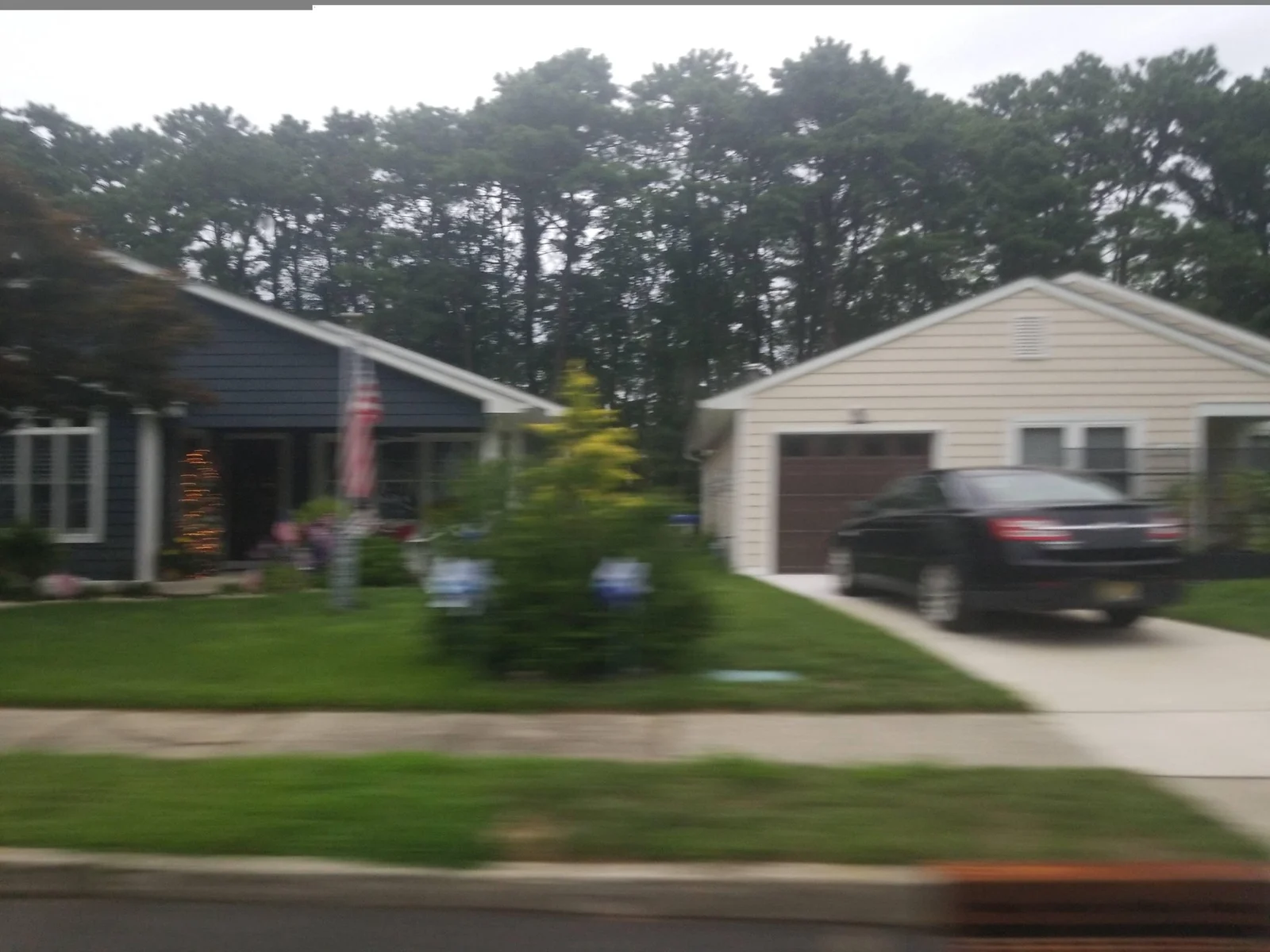 Two single-story homes with garages and landscaped front yards