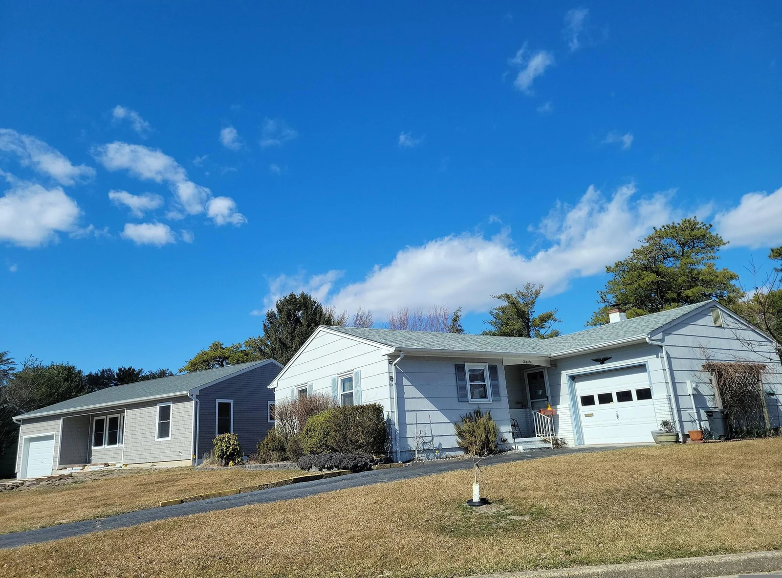Single-story home with an attached garage on a sloped lawn