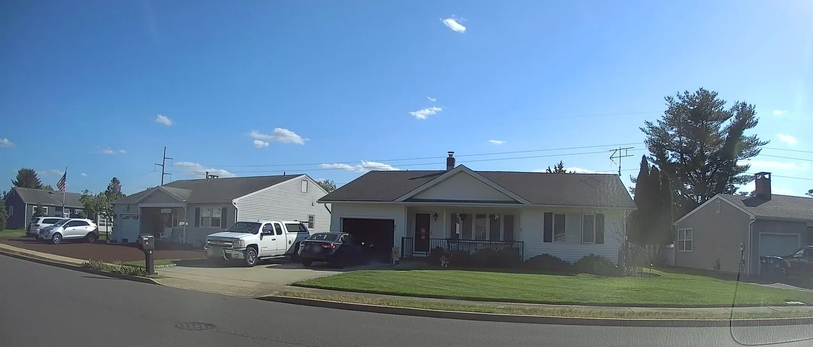 Single-story homes with lawns along a residential street