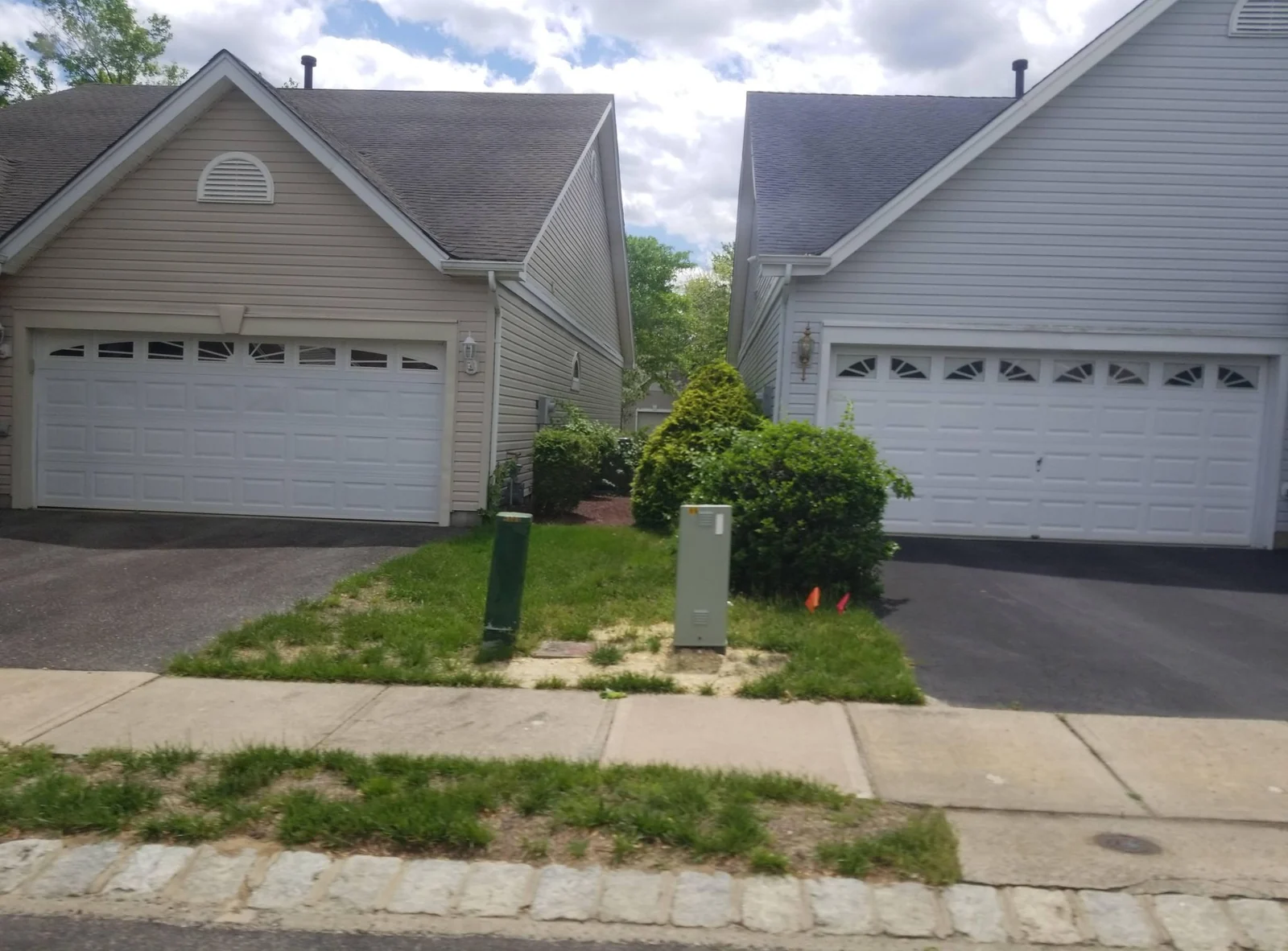 Two homes side by side with two-car garages