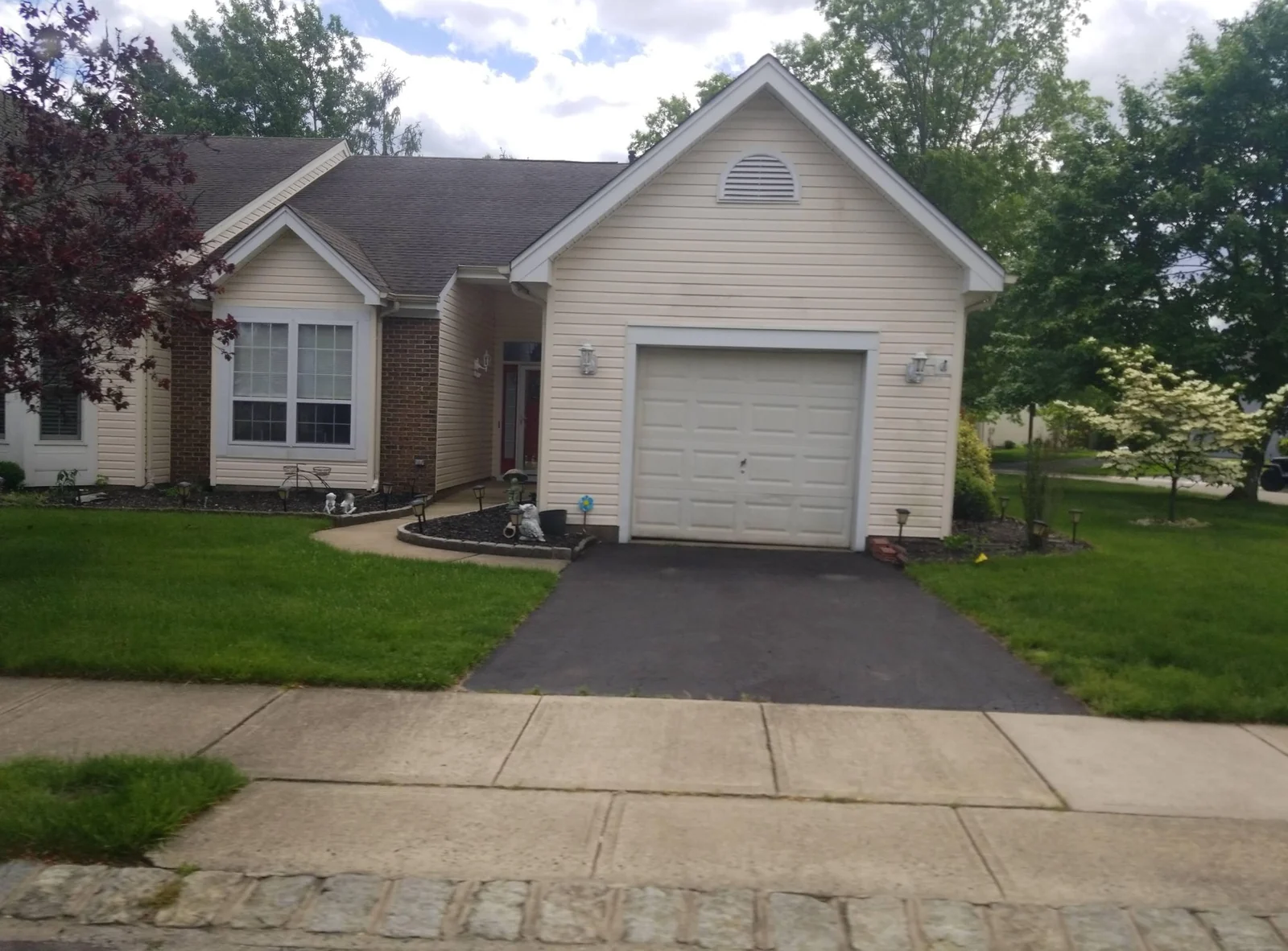 Single-story home with an attached garage and a green lawn