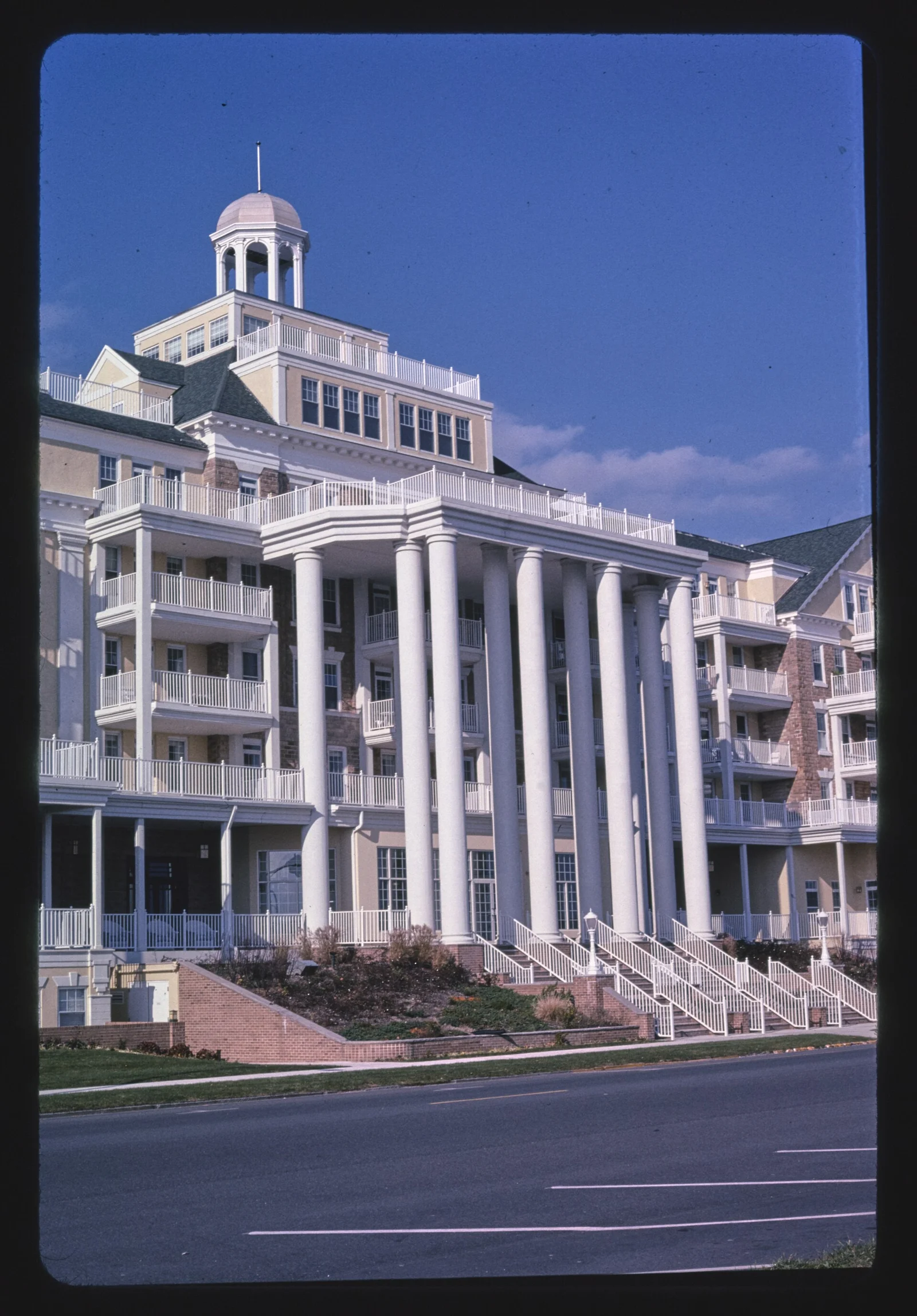 Tall columned portico and front steps of the Essex and Sussex beside Ocean Avenue
