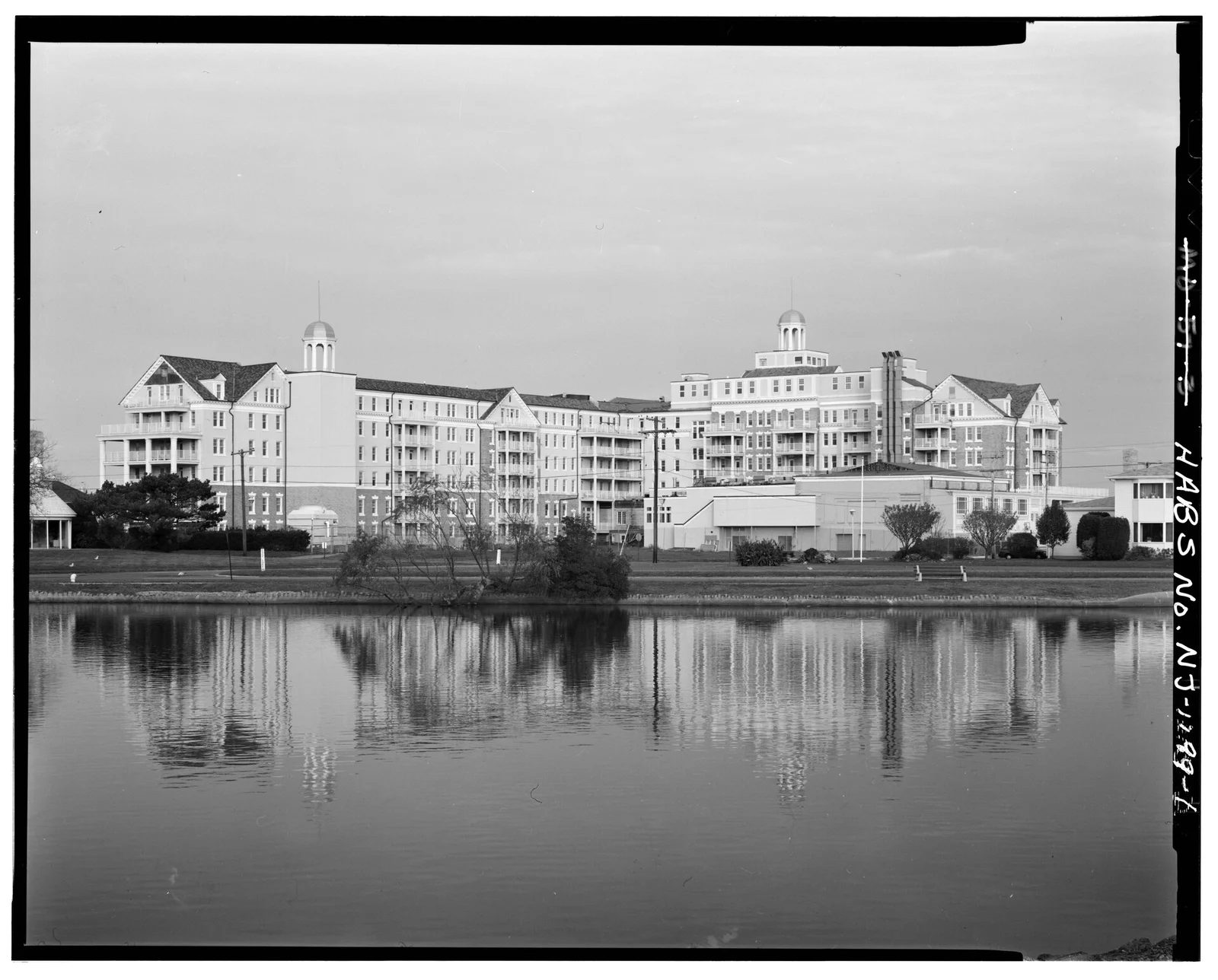 Black and white photo of the hotel reflected in still water