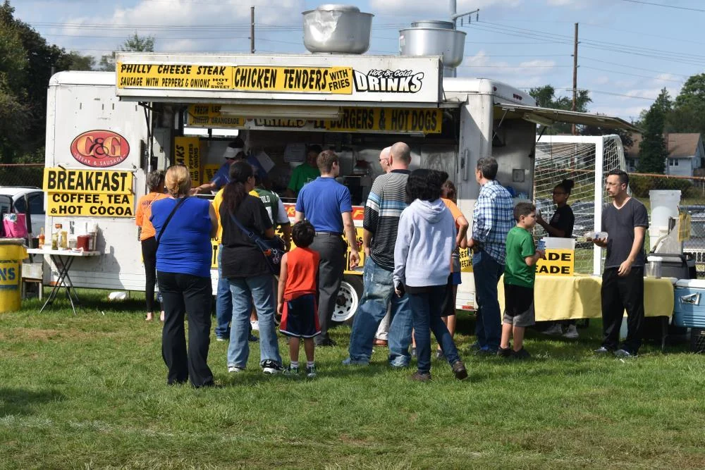 Visitors lined up at a food truck selling cheesesteaks and chicken tenders at Aberdeen Day
