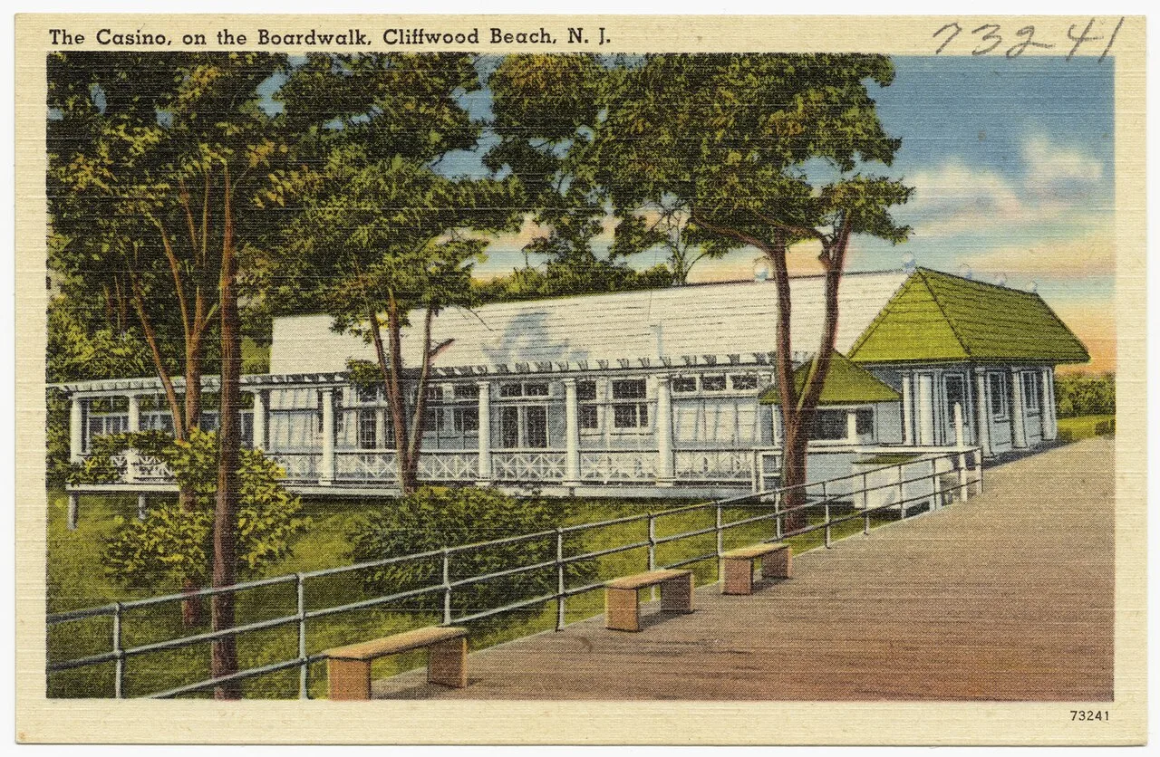 Vintage color postcard of the Casino building on the boardwalk at Cliffwood Beach, framed by trees