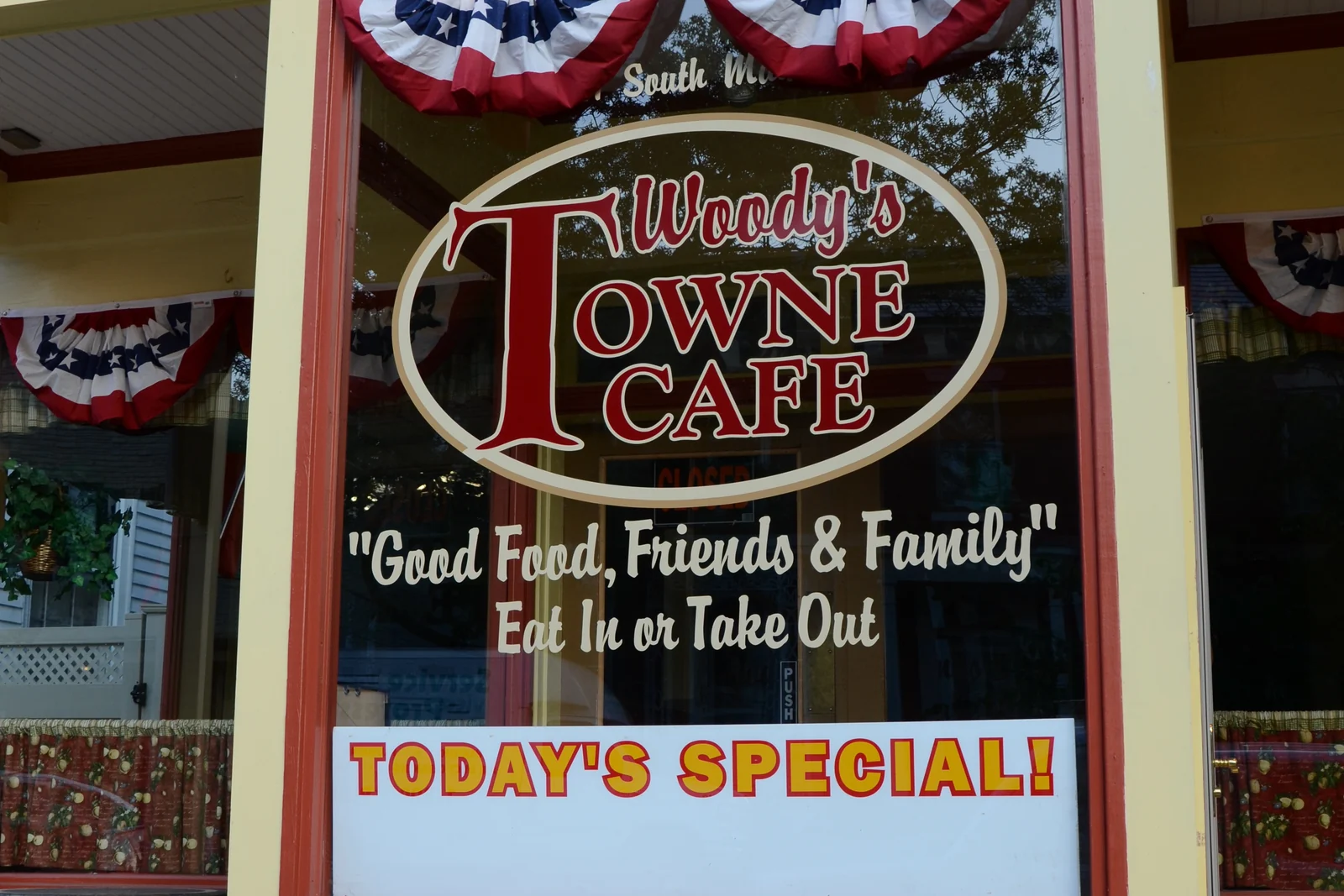 The front window of Woody's Towne Cafe on South Main Street, trimmed with red, white and blue bunting