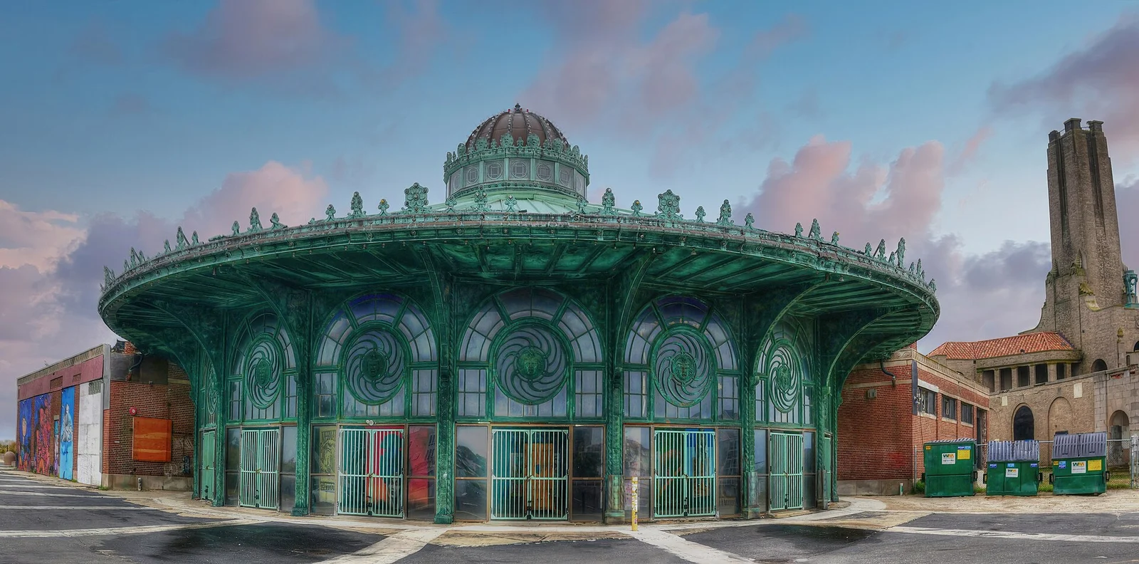 The round green Carousel House with its copper dome and arched windows, the brick Steam Plant tower behind it