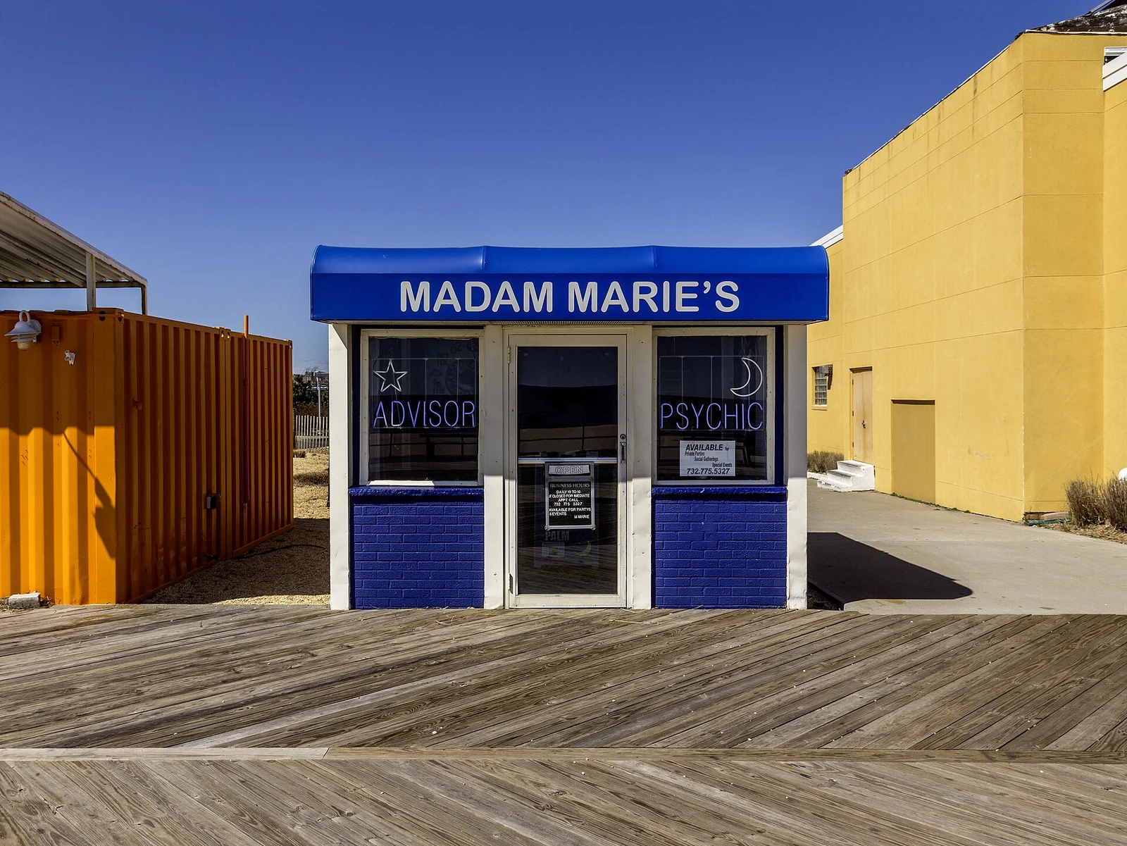 The small blue Madam Marie's fortune-teller booth on the boardwalk planks