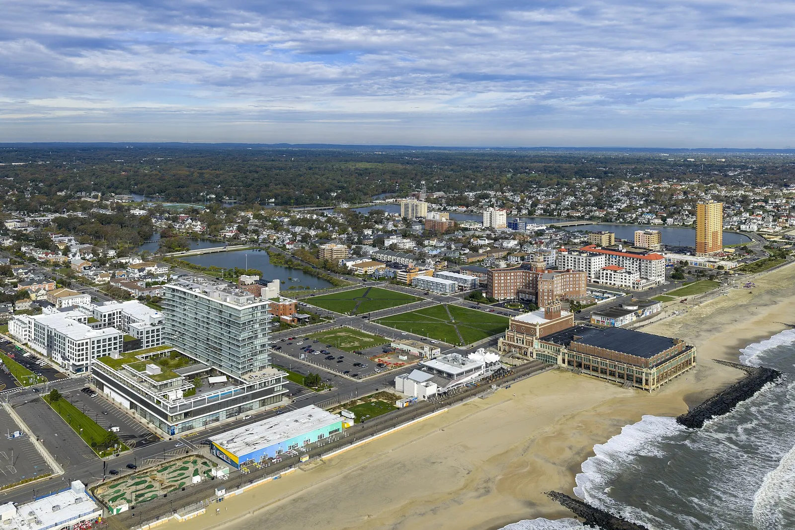 Aerial view of the Asbury Park beachfront, boardwalk and town stretching inland from the ocean