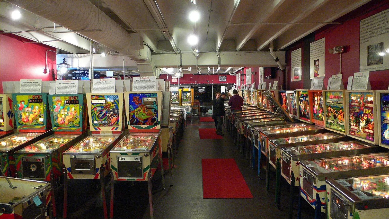 Rows of lit-up vintage pinball machines inside the Silverball Museum