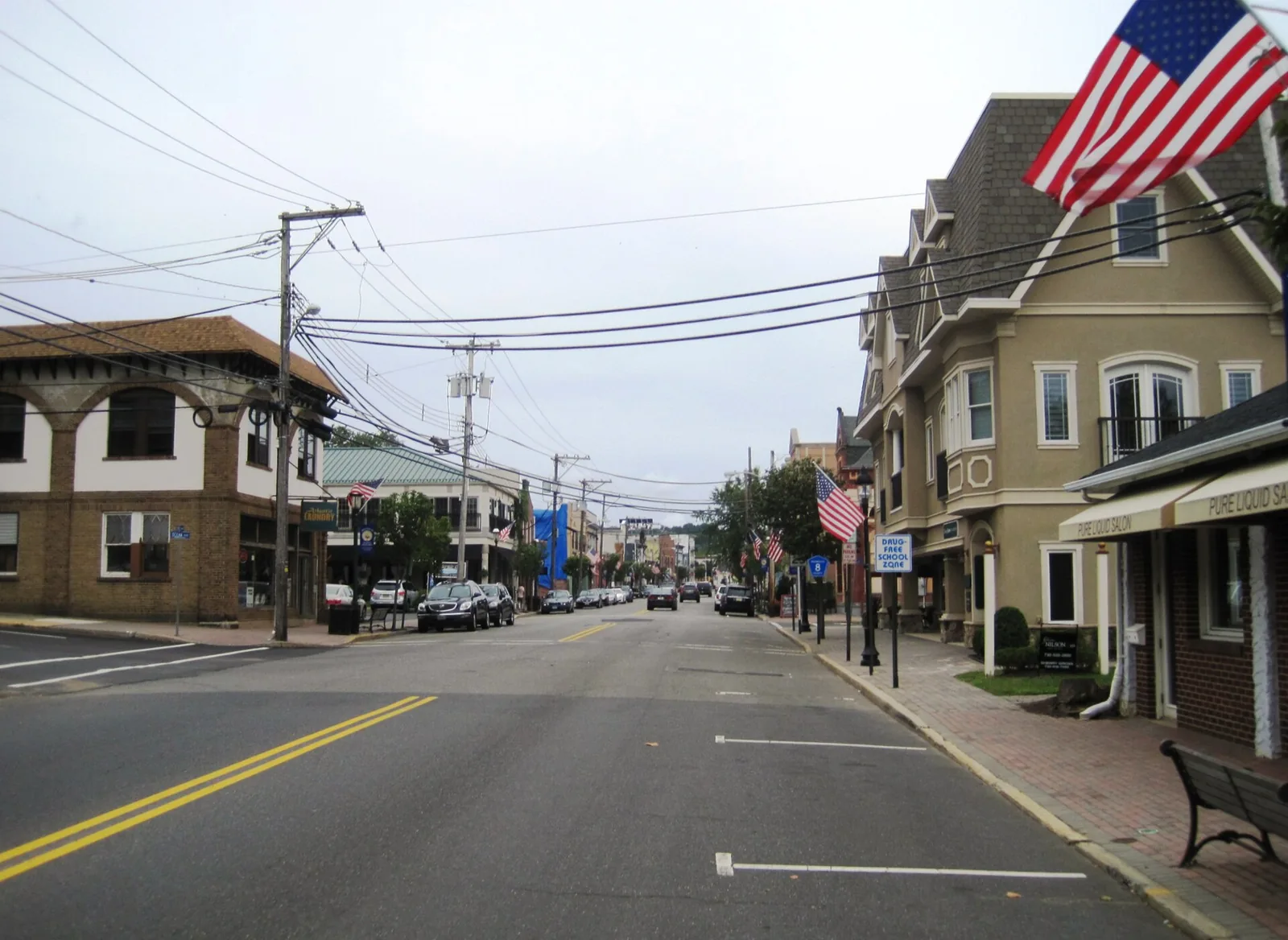 First Avenue in downtown Atlantic Highlands, lined with shops, brick sidewalks and American flags