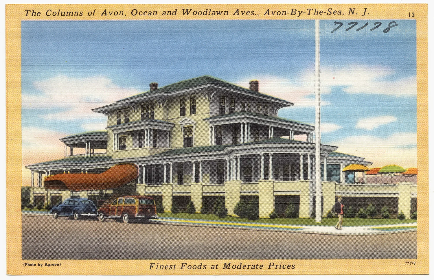 Vintage linen postcard of The Columns, a large columned seaside building with wraparound porches at Ocean and Woodlawn Avenues, with 1940s cars out front