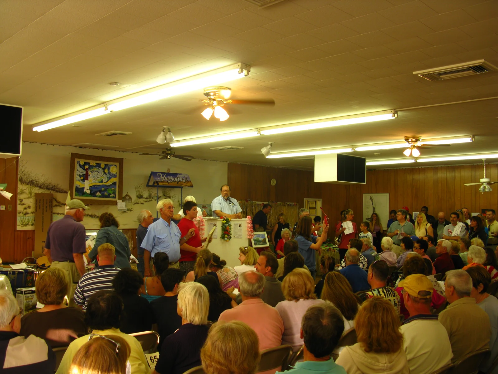 A packed hall of bidders seated in rows during an auction at the Barnegat Light fire hall