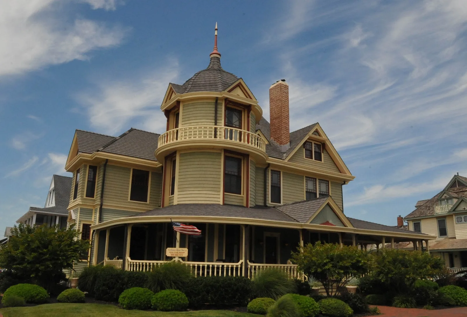 The Dr. Edward H. Williams House, a yellow Victorian with a round tower and porch, in Beach Haven