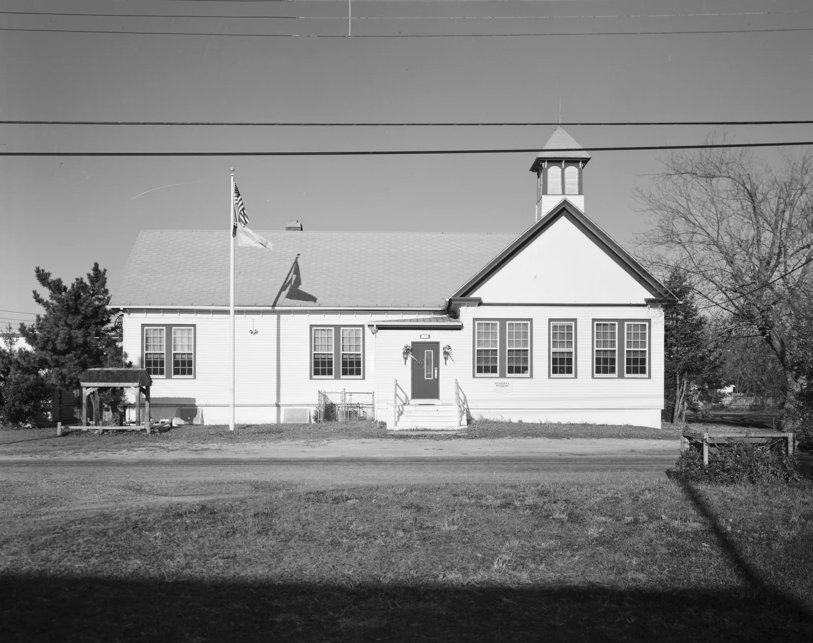 Black and white photo of a white clapboard schoolhouse with a cupola on Division Street in West Creek