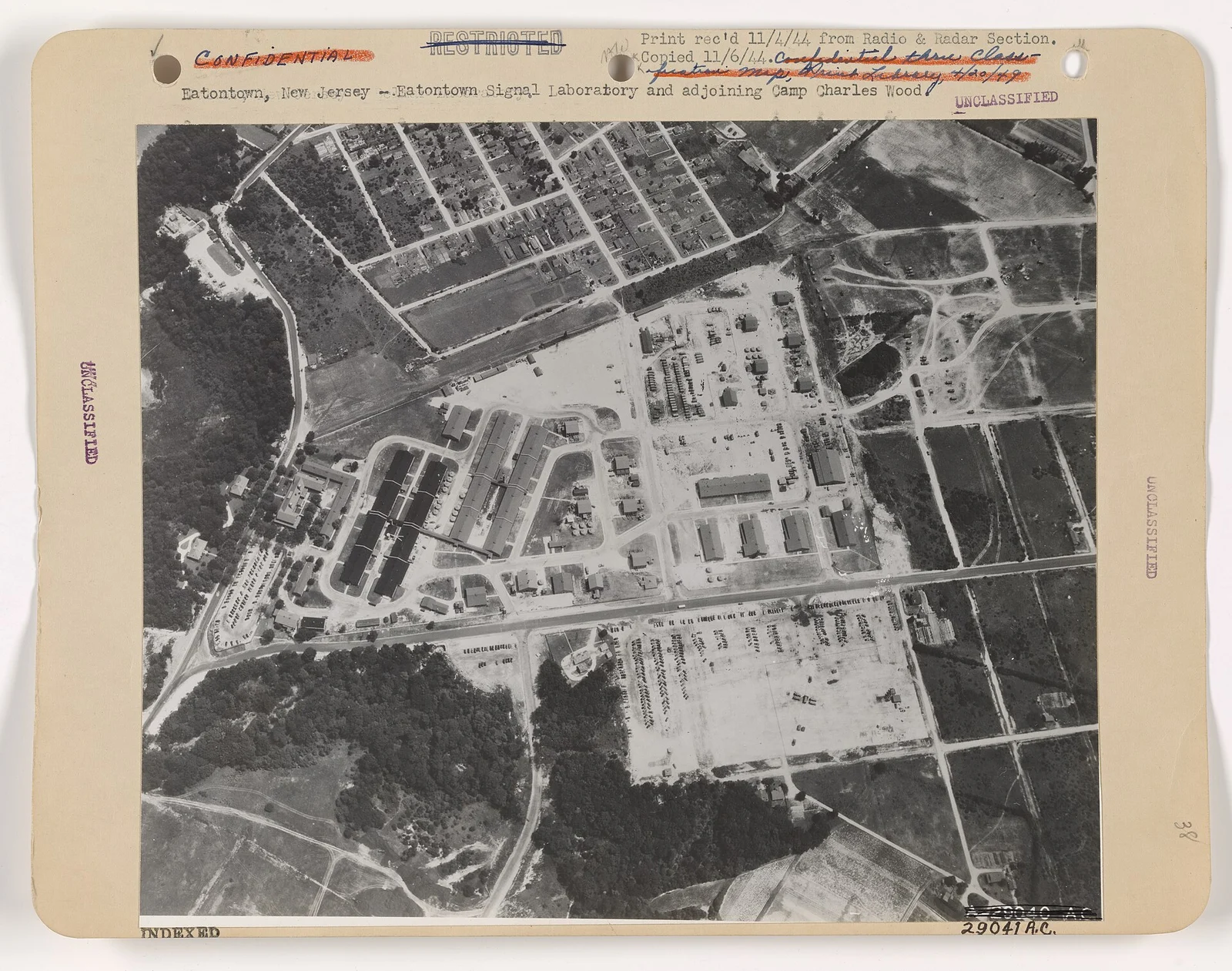 Historic black and white aerial photo of the Eatontown Signal Laboratory and Camp Charles Wood, with rows of buildings, roads and woods