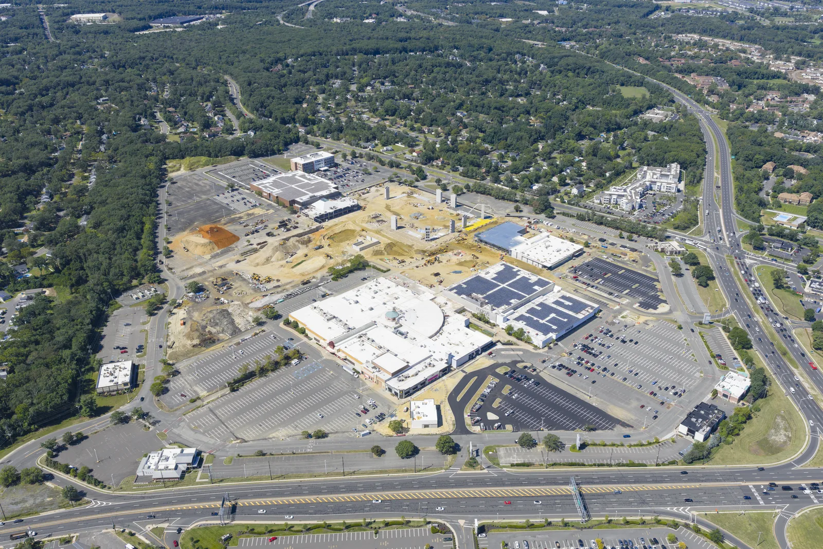 Aerial view of the Monmouth Mall property at Routes 35 and 36 during renovation work in August 2025, with the surrounding roads and neighborhoods