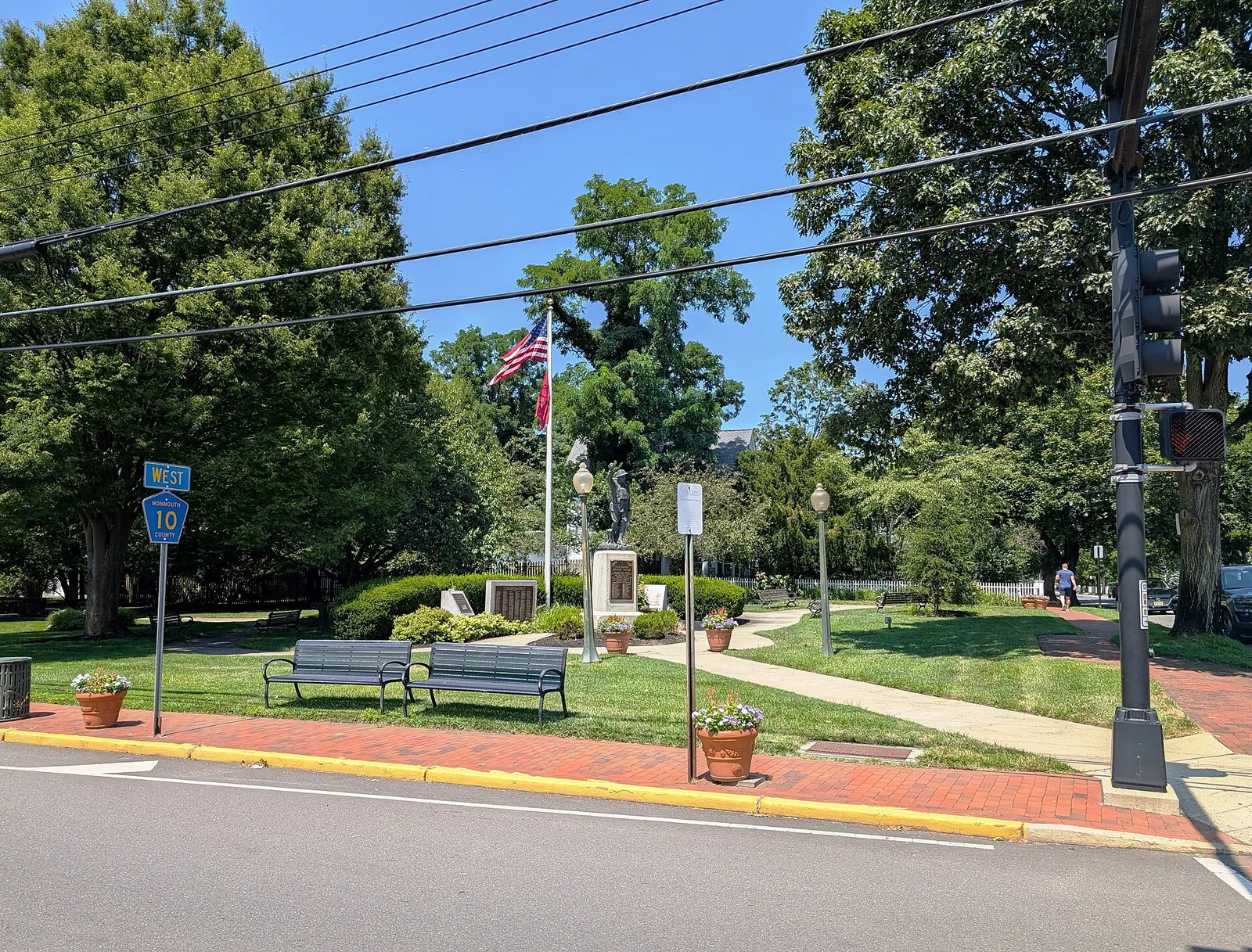 The Fair Haven veterans memorial park with benches, flags and shade trees on River Road