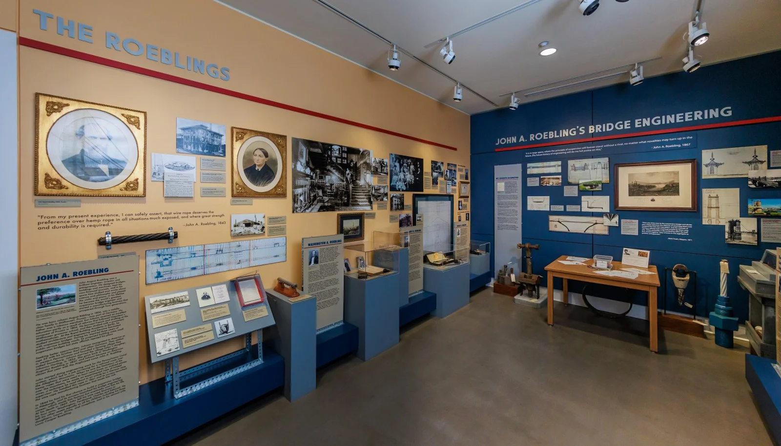Exhibit panels about John A. Roebling's bridge engineering lining a gallery inside the Roebling Museum