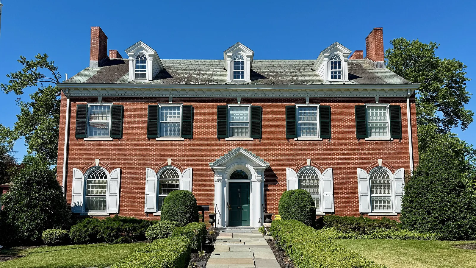 The red brick Monmouth County Historical Association building with white trim and dormers
