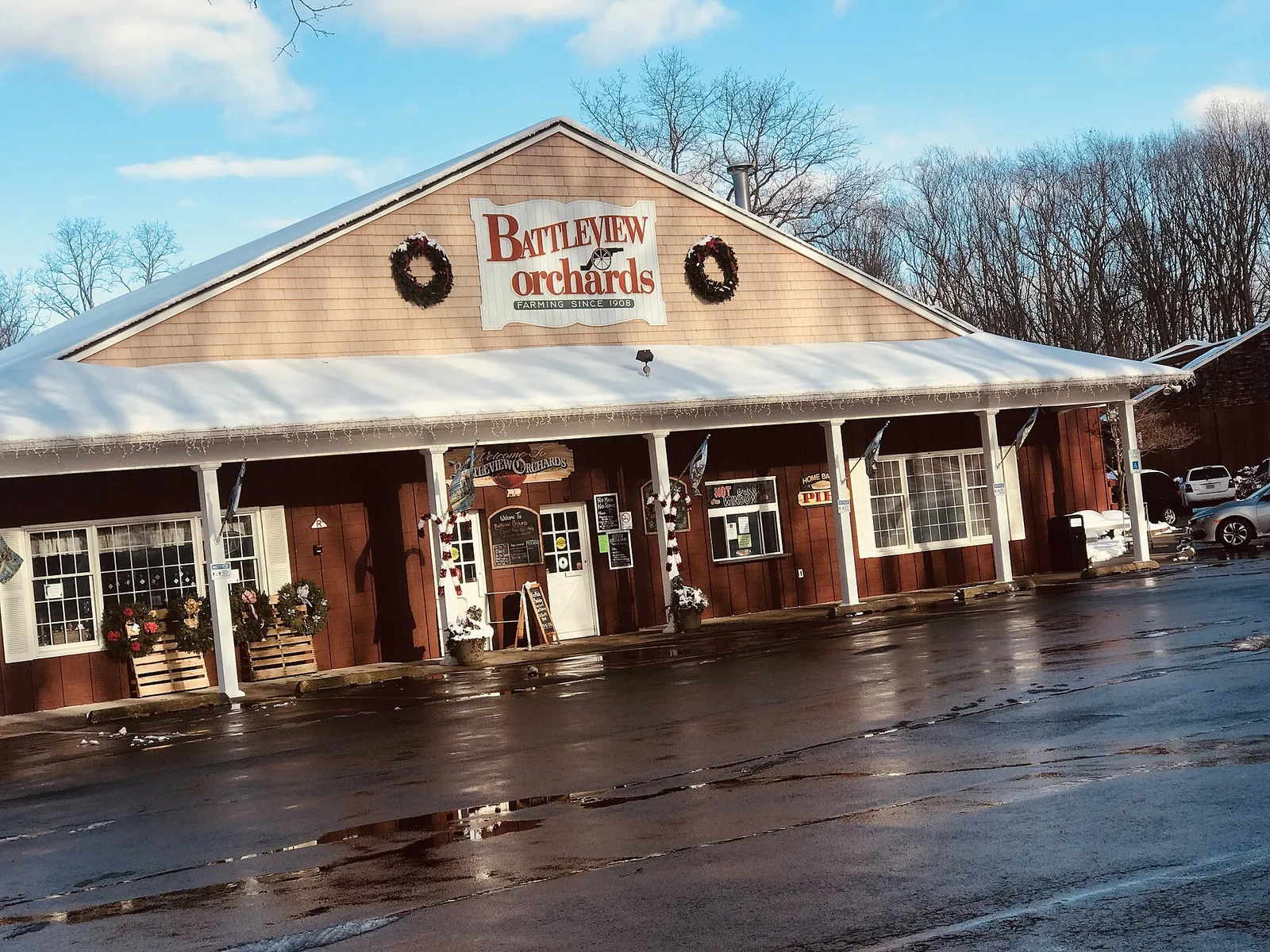 Front of the Battleview Orchards farm market building with wreaths over the doors