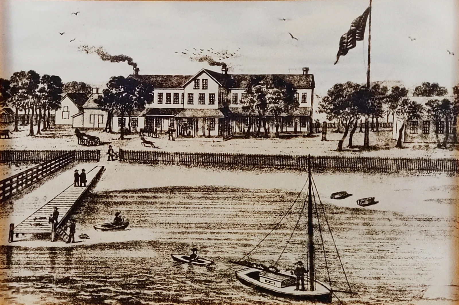 Mid-1800s drawing of the Harvey Cedars Hotel with a flagpole, a dock on the bay and a sailboat in front