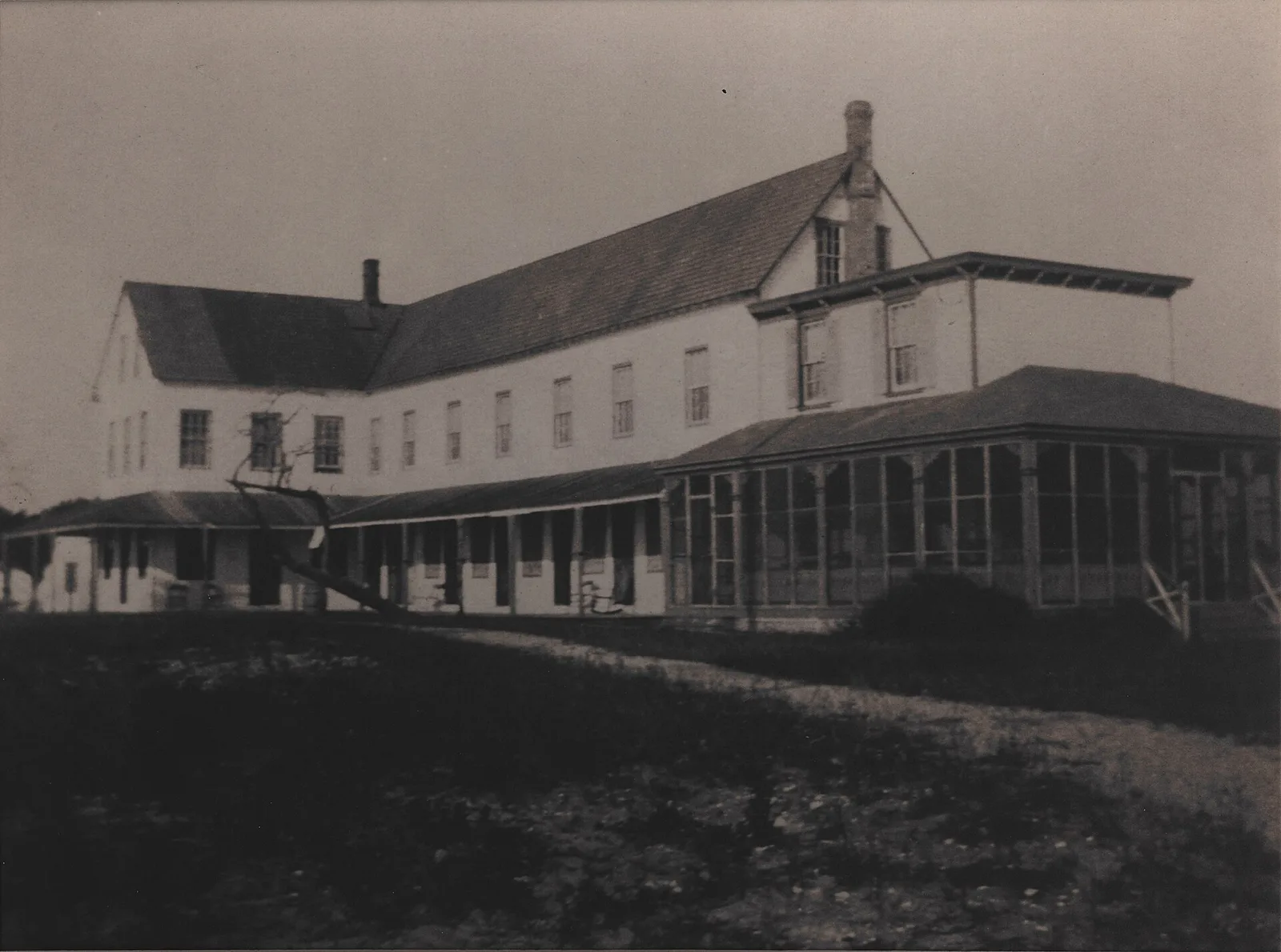 The Harvey Cedars Hotel, a long white wooden hotel with a wide porch, photographed before its 1903 renovation