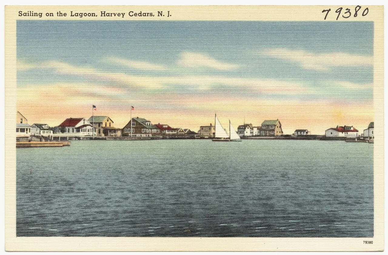 Vintage postcard of a sailboat on calm bay water with shore cottages behind