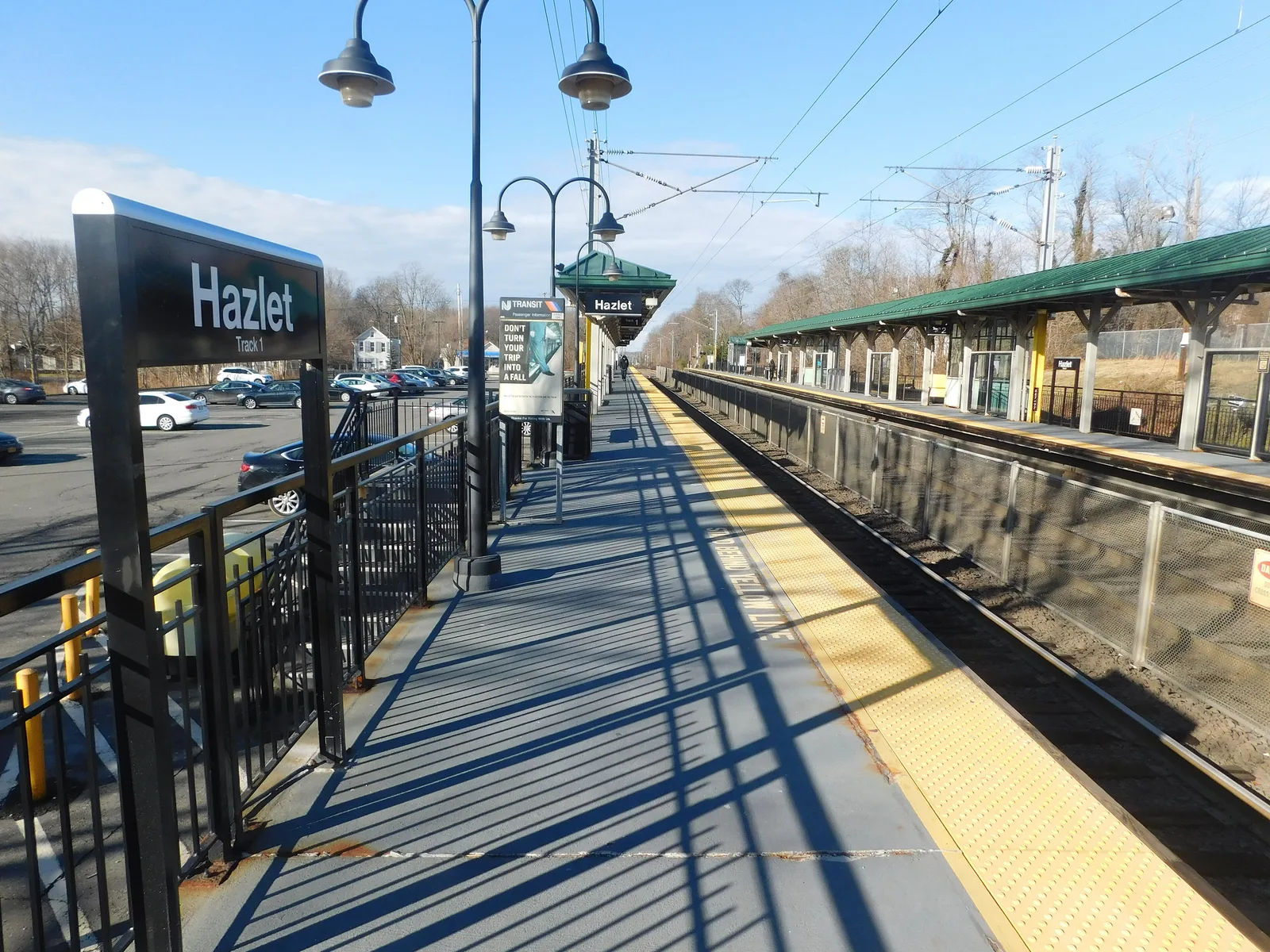 The Hazlet train station platform on the North Jersey Coast Line, with its station sign, lamp posts and canopy