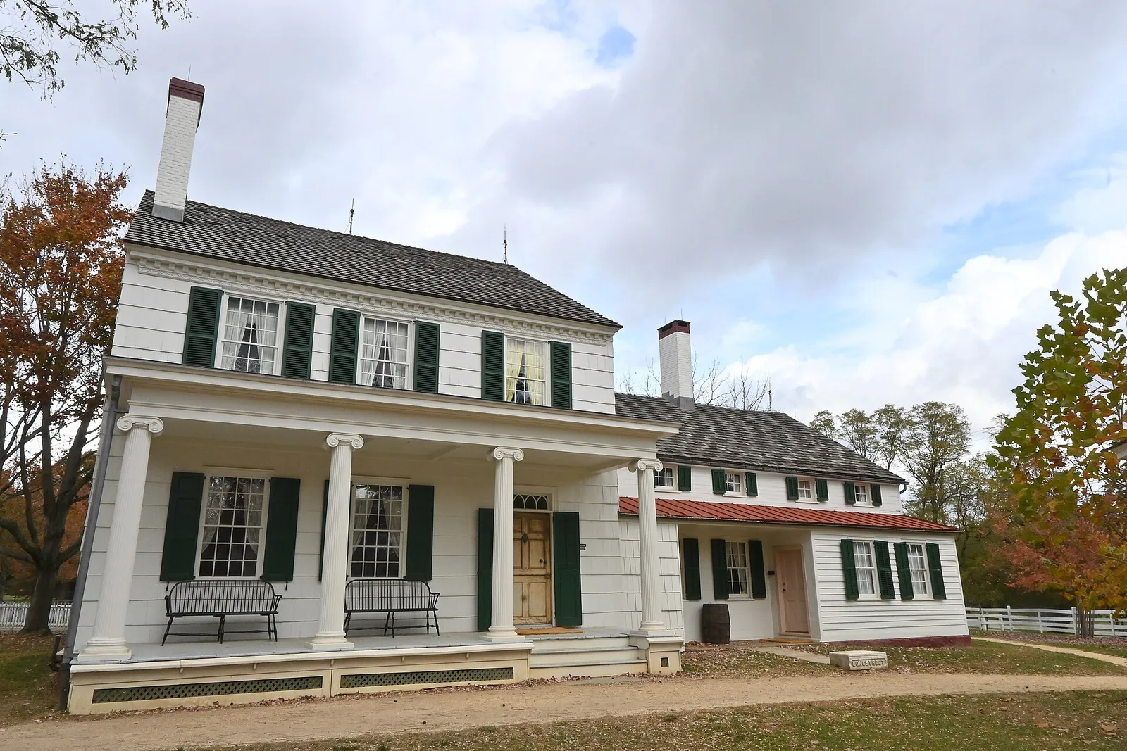 The white farmhouse with a columned porch at Longstreet Farm in Holmdel Park