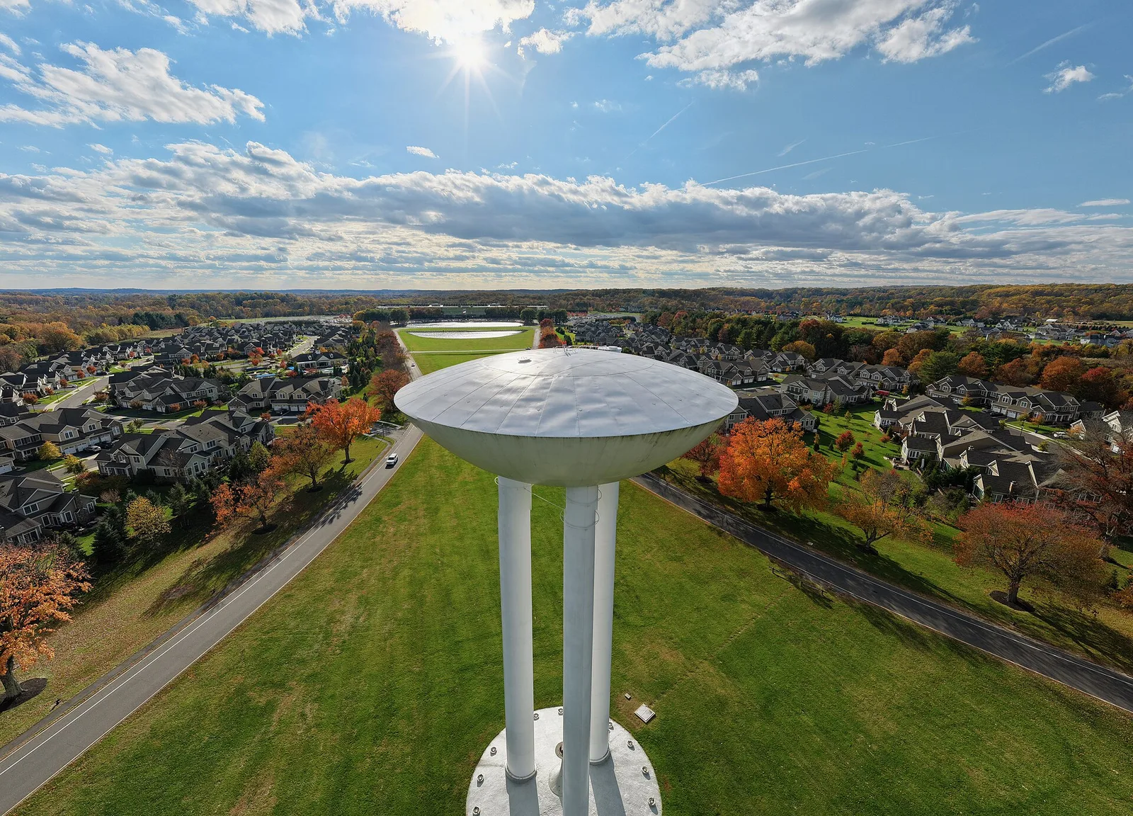 The transistor-shaped water tower at Bell Works seen from above against a bright sky