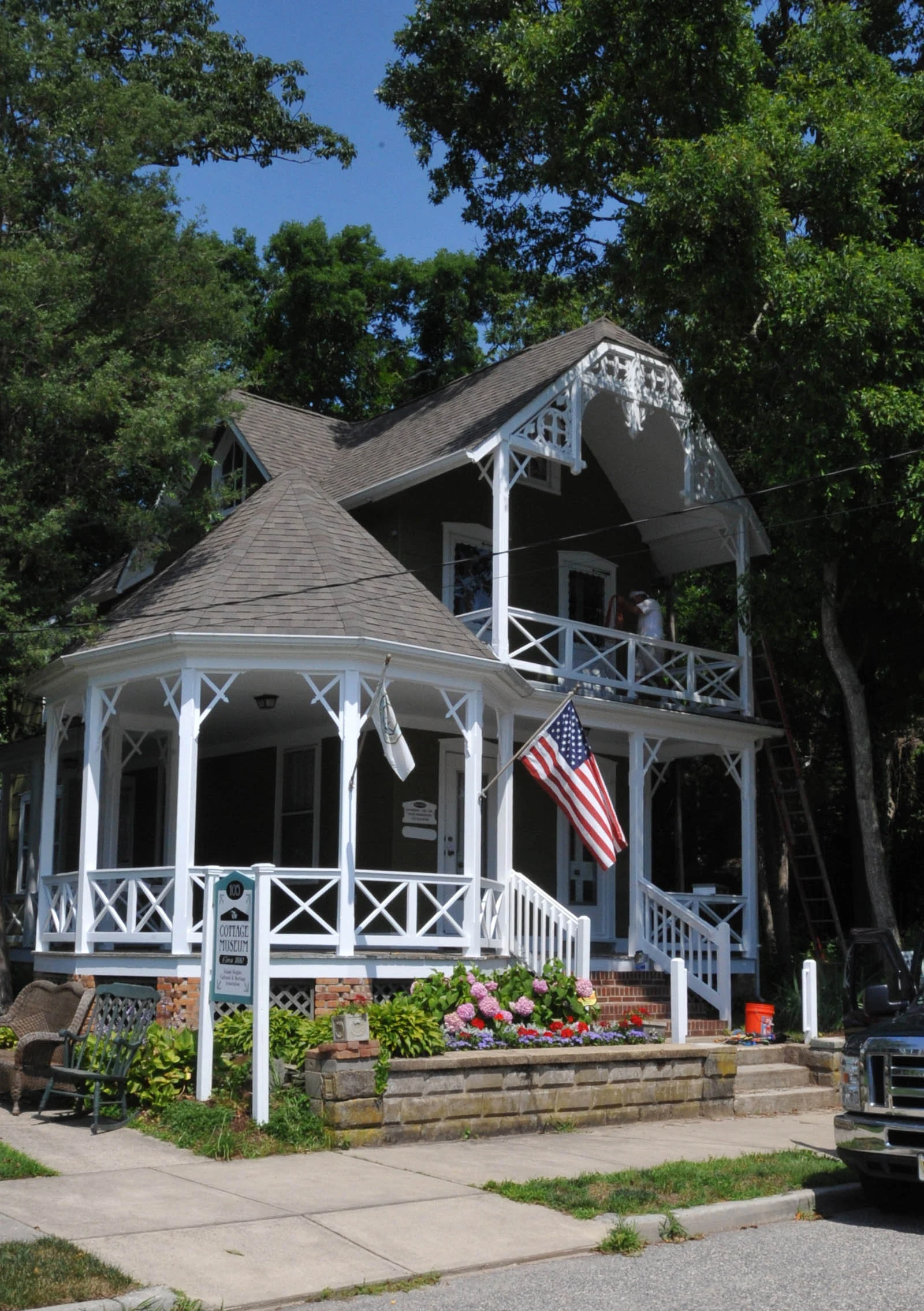The Cottage Museum, an 1880s Carpenter Gothic cottage with lacy trim, a round porch and flower boxes
