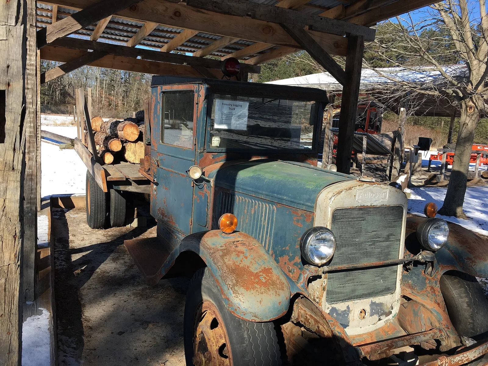 A 1930s Autocar logging truck loaded with logs on display at the Forest Resource Education Center
