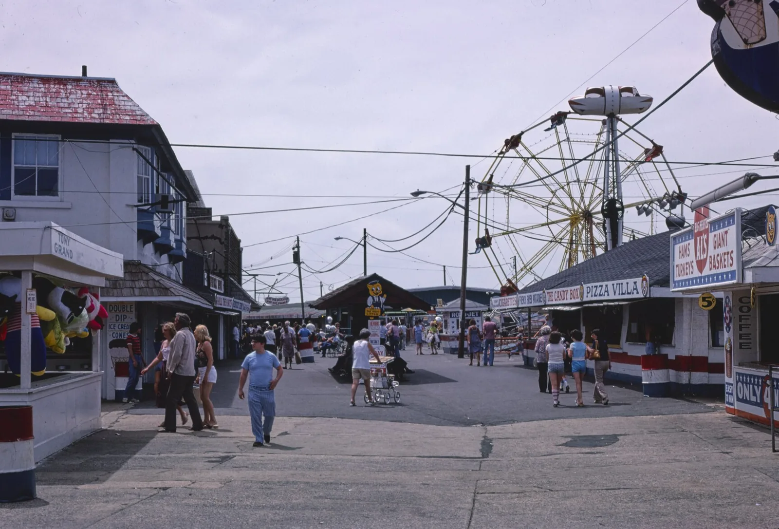 The Keansburg boardwalk in 1978 with game stands, food counters and a Ferris wheel