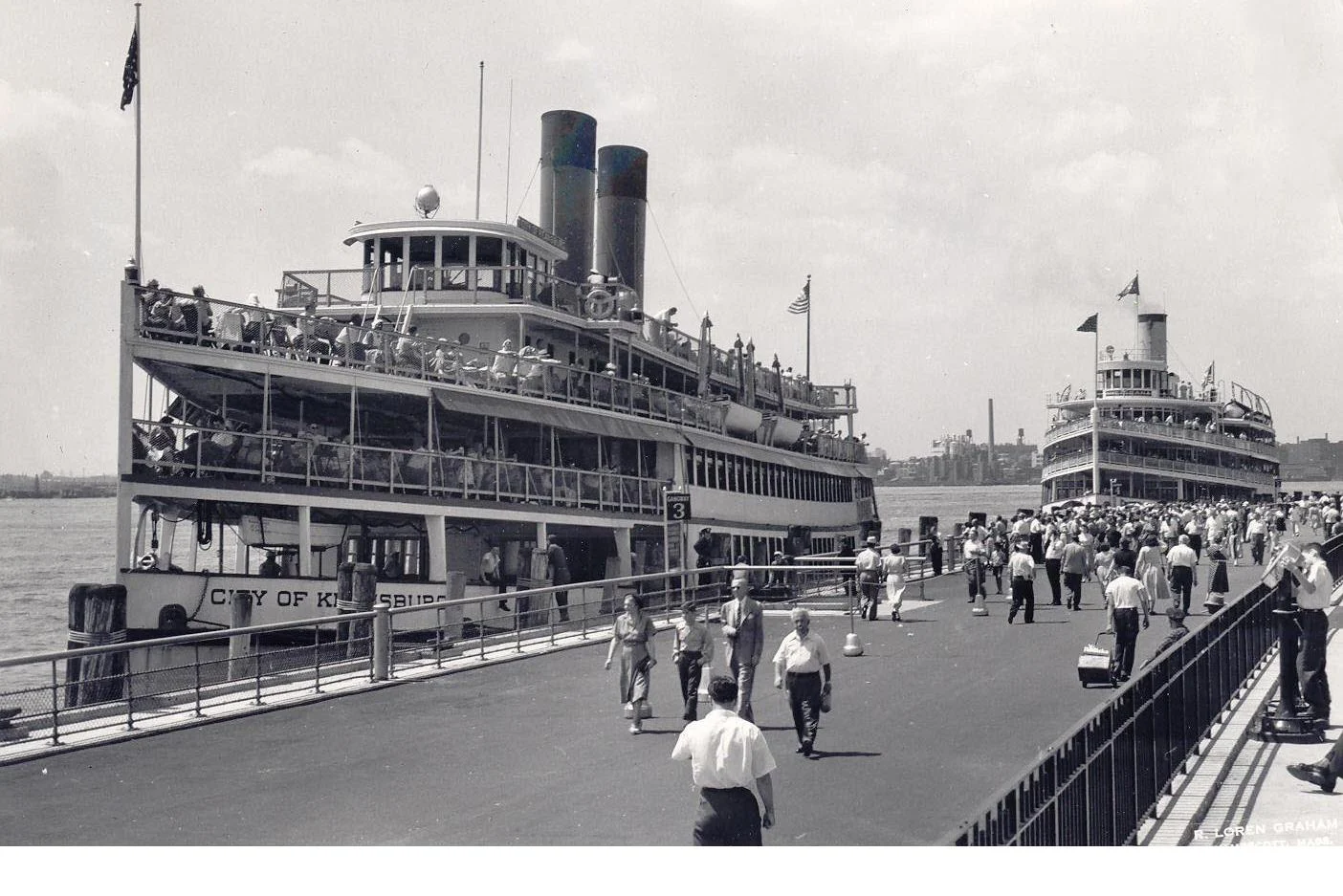 Black and white photo of crowds on a pier beside the steamboat City of Keansburg, a second steamer behind