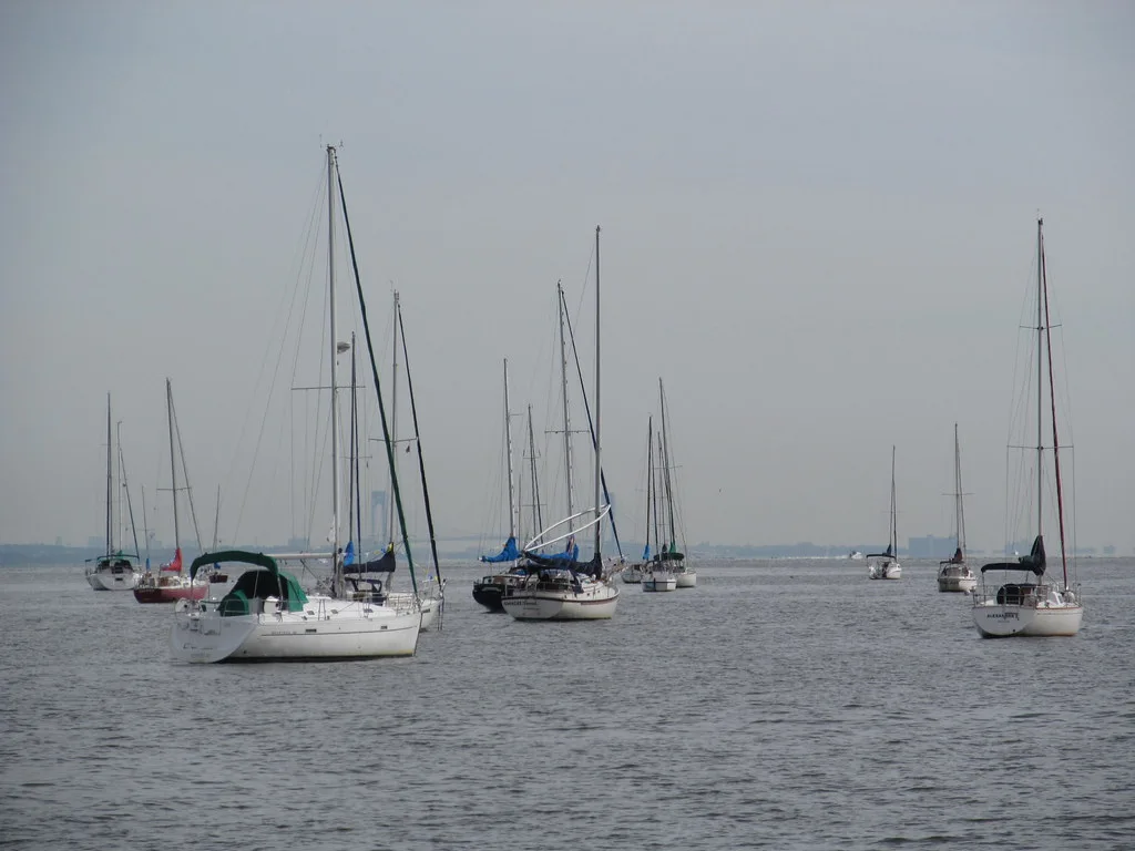 Sailboats moored in Keyport Harbor on a hazy day