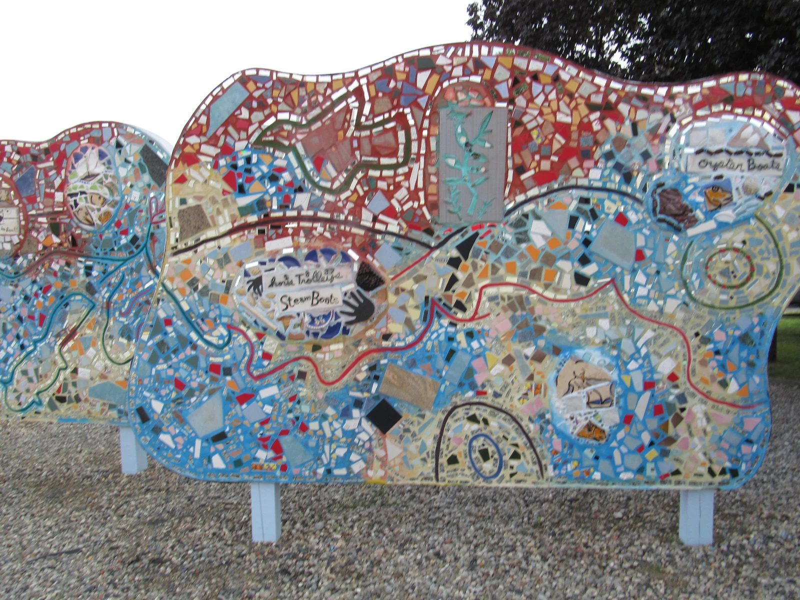 A wavy public art wall covered in colorful tile and glass mosaic on the Keyport waterfront