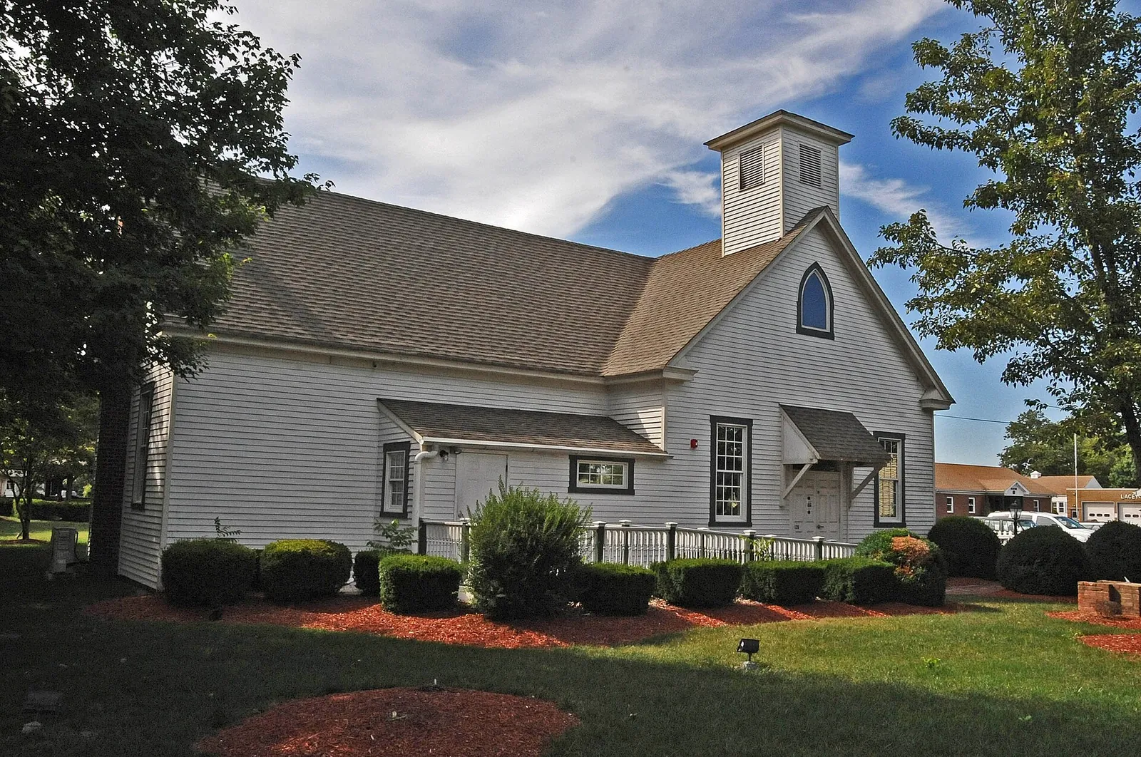 White clapboard schoolhouse with a cupola, now the Lacey Schoolhouse Museum