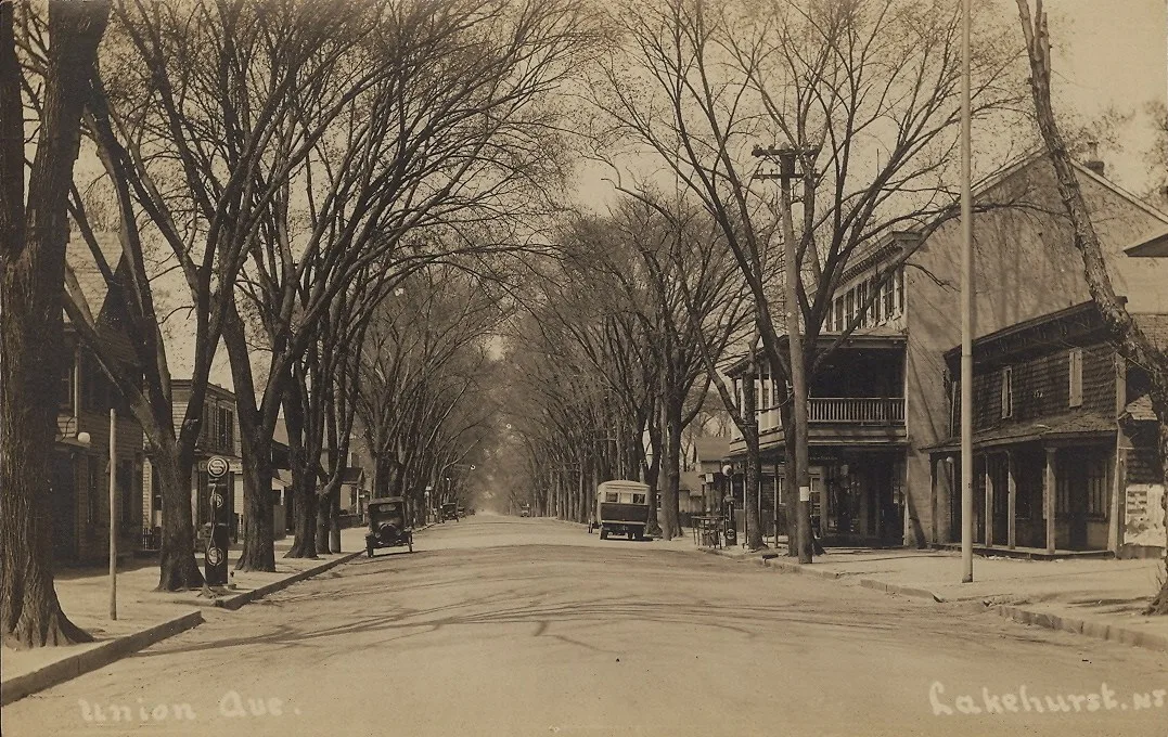 Old sepia postcard of tree-lined Union Avenue in Lakehurst around 1910, with storefronts on the right