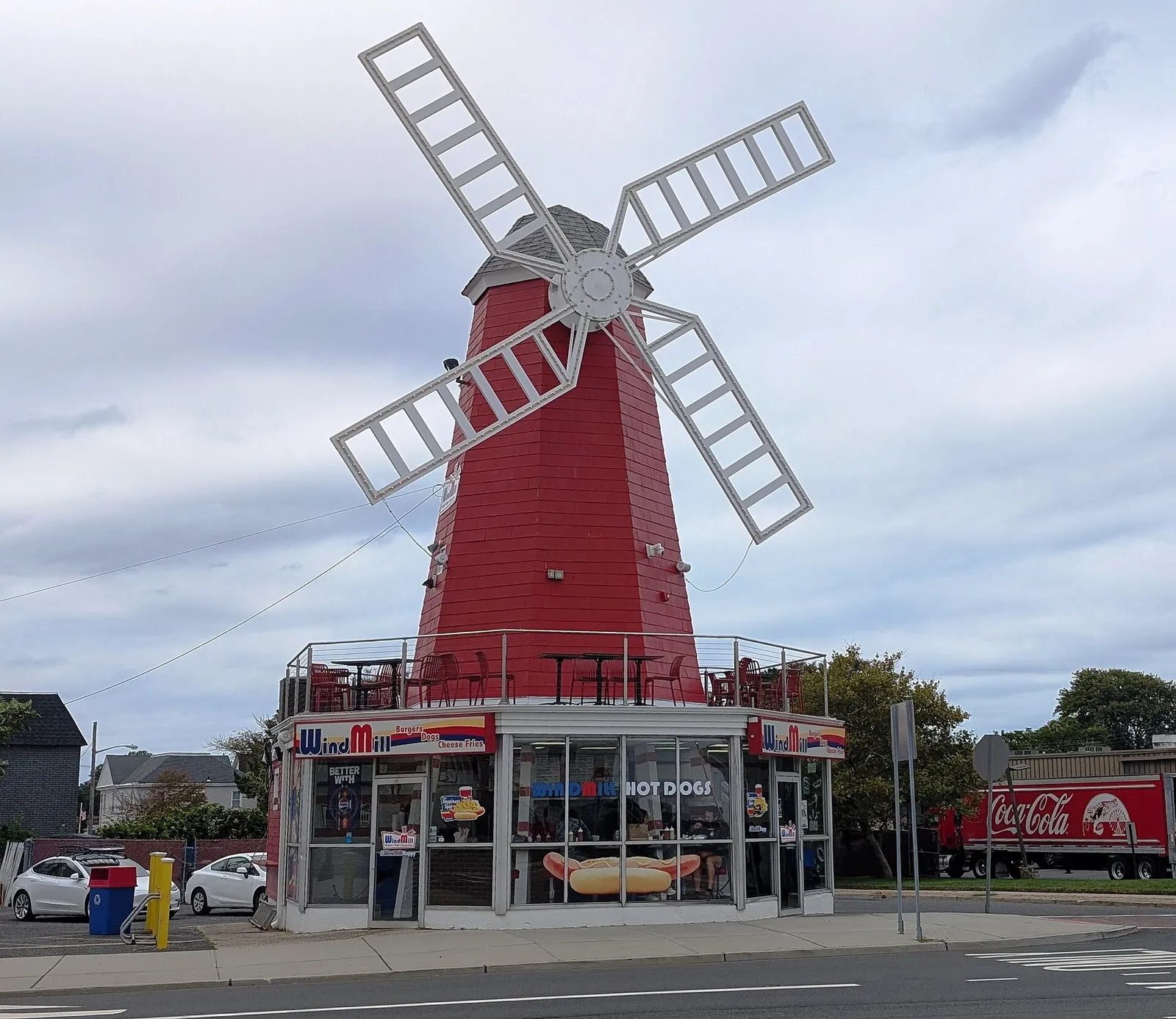 Red windmill-shaped restaurant building with white sails
