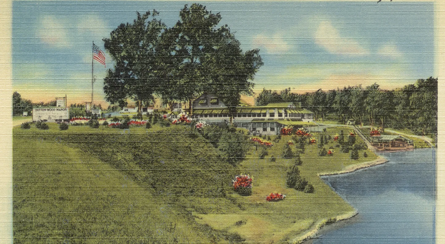 Vintage color postcard of Buttonwood Manor with lawns and flower beds sloping down to the shore of Lake Lefferts