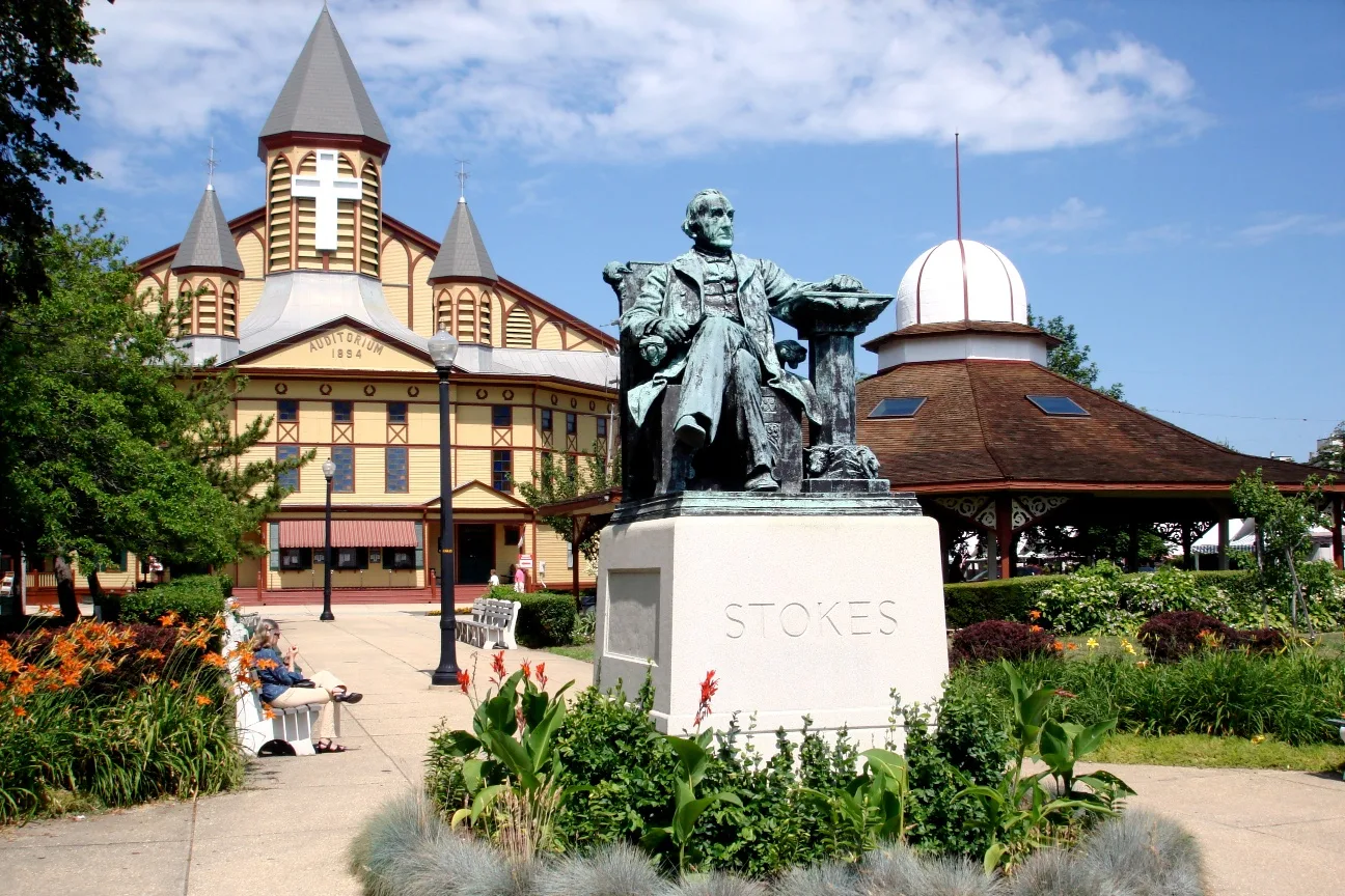 The Great Auditorium in Ocean Grove behind the statue of Ellwood H. Stokes and summer gardens on Ocean Pathway